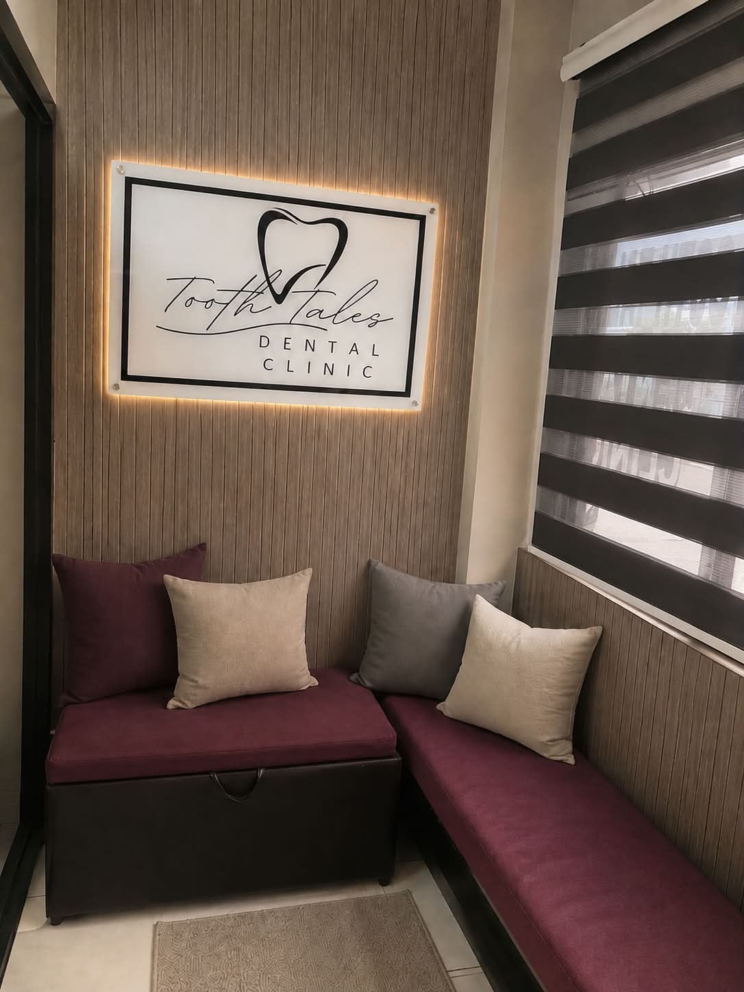The Tooth Tales Dental Clinic waiting area, with the clinic sign above the seating